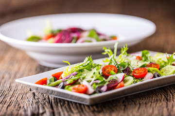Vegetable salad. Plate of salad with vegetables  on rustic oak table. Assortment of ingredients of vegetable salad.