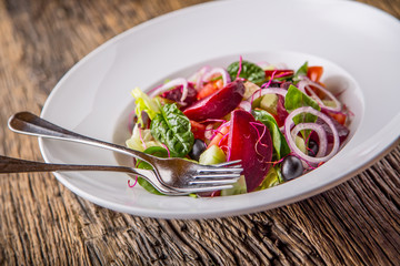 Vegetable salad. Plate of salad with vegetables  on rustic oak table. Assortment of ingredients of vegetable salad.