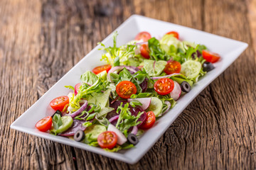 Vegetable salad. Plate of salad with vegetables  on rustic oak table. Assortment of ingredients of vegetable salad.