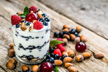 Healthy yogurt with fruits or sundae ice cream in a cup, summer dessert concept