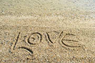 Word Love written on the beach