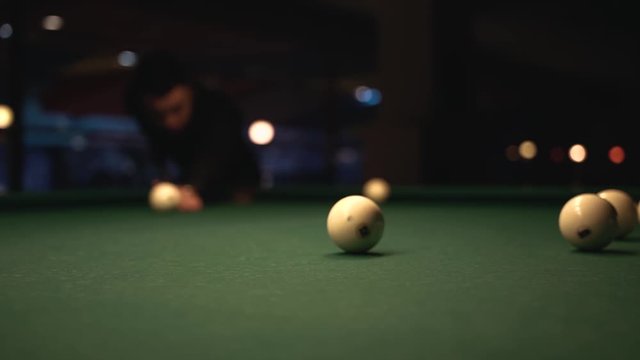 Young Man Aiming to Take a Billiard Shot. Playing Snooker Background.