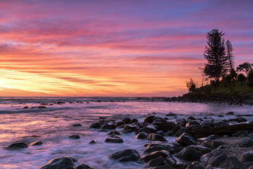 Fototapeta na wymiar Colourful red and yellow sunrise colours in the clouds at Burleigh Heads Gold Coast.