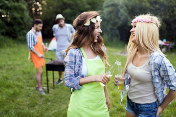 Two beautiful women having fun while waiting for barbecue