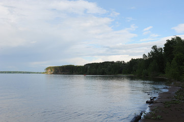 Water landscape on a summer clear day. Blue sky, clouds. Islands far away