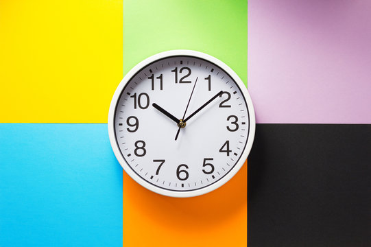 Wall Clock At Abstract Colorful Paper