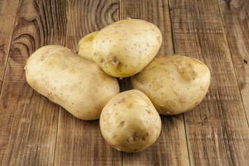 Raw, young potatoes on a wooden table