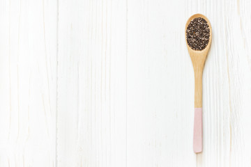 Wooden spoon with Chia seeds in white wooden table. Concept of a healthy diet.