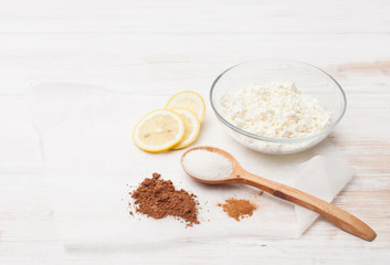Cocoa, cinnamon, cottage cheese, lemon and sugar on the table