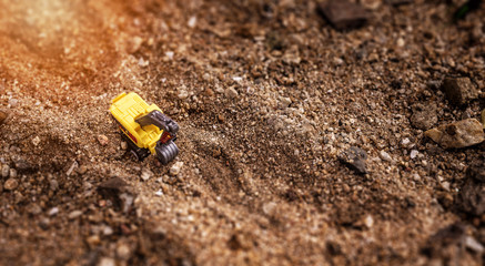Plastic Backhoe Toy Car on Sand Beach - Tilt-Shift Miniture Style