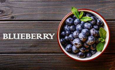 Blueberry. Freshly picked blueberries over wooden table.