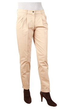Slim woman in fashionable pants stands against a white background