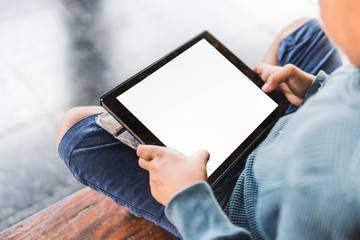 young boy playing tablet,blank screen tablet holding by hand,selective focus and vintage tone