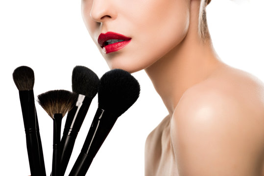 Cropped Shot Of Sensual Young Woman Holding Makeup Brushes Isolated On White