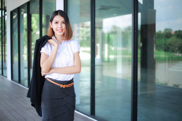 Fototapeta na wymiar Modern business women casual outfits in the office with copy space, Business woman standing cross one's arm, Asian people young beautiful businesswoman smile. business concept