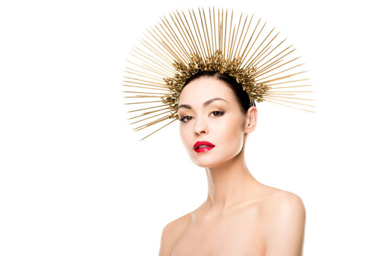 portrait of glamorous naked model posing in golden headpiece isolated on white
