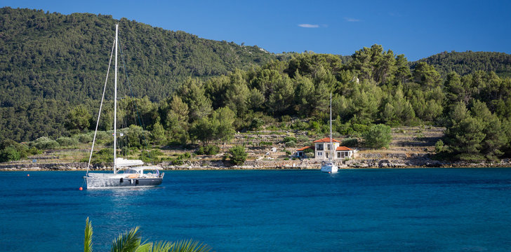 Fototapeta Yachts on blue lagoon bay at Croatia