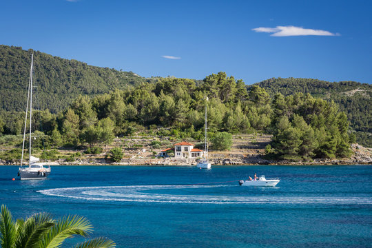 Fototapeta Yachts on blue lagoon bay at Croatia