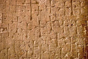 cross hanging on a stone wall, in Church of the Holy Sepulcher in Jerusalem