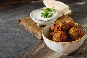 Middle Eastern traditional dishes. Falafel with sour cream. Vegetarian food.