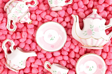 Small tea set in pink. Miniature ceramic tea cups and tea pots. Concept of love and Valentine's day