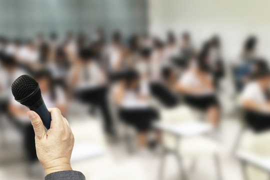 Education Background with copy space  shown teacher hold microphone in hid hand to lecture for his students in the classroom.