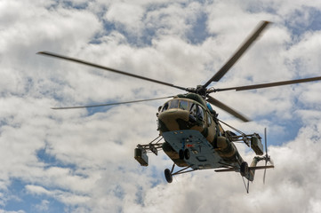 Tyumen, Russia - June 21, 2017: Army Games. Safe Route contest. Military helicopter MI-8 in the cloudy sky