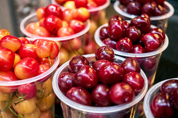Cherry red and yellow in plastic glasses light
