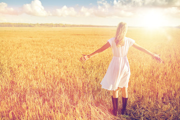 Fototapeta na wymiar happy young woman in white dress on cereal field