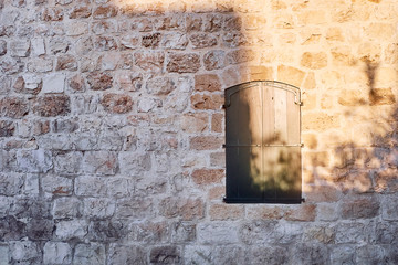 old window and stone wall with sunset light