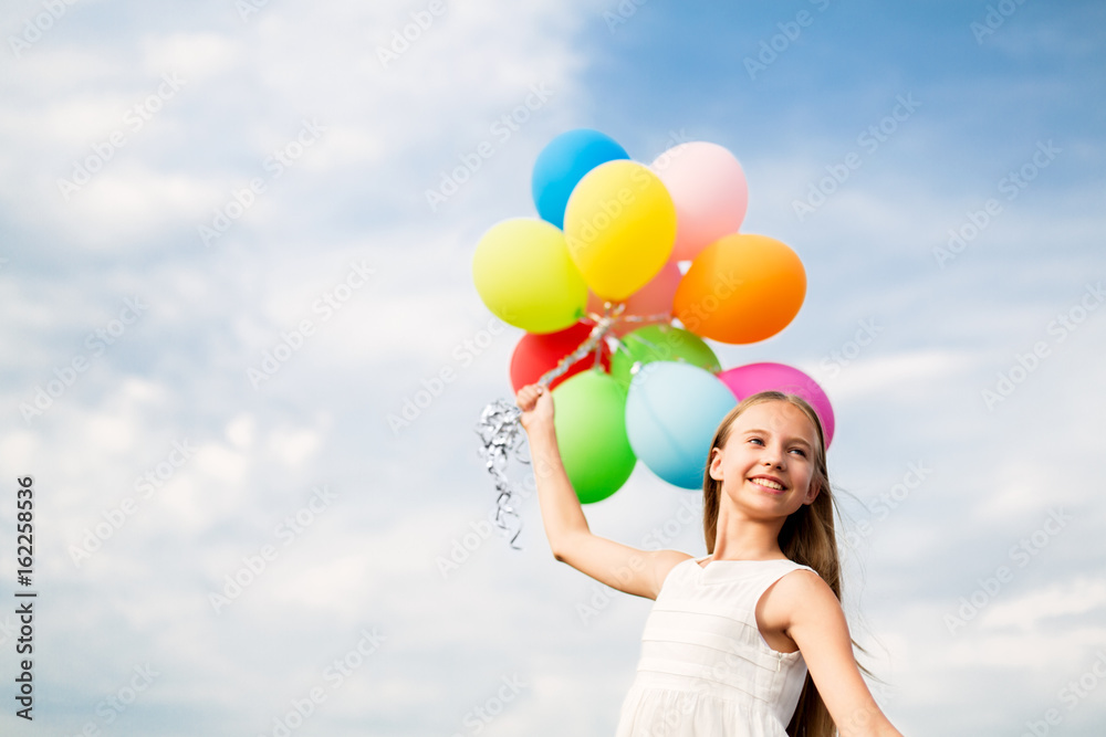 Wall mural happy girl in sunglasses with air balloons