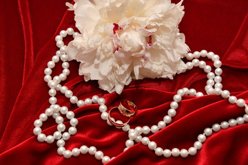 Two wedding rings and Peony flower.