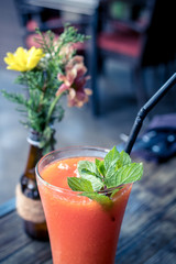 Healthy fruity papaya juice in a glass on a wooden table. Bali island.