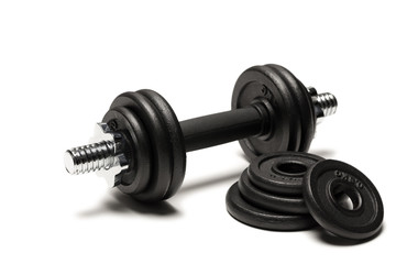 close up of iron dumbbell with weight plates isolated on white