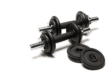 black iron dumbbells with weight plates isolated on white