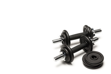 black iron dumbbells with weight plates isolated on white