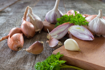 Shallot onion and garlic on a wooden background © artverau
