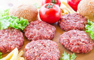 The raw ingredients for the homemade burger on country background.