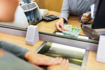 clerk counting cash money at bank office
