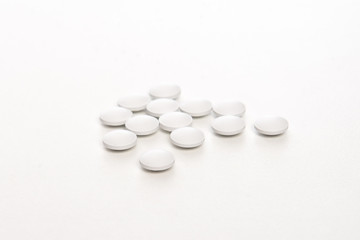 white pills on white background