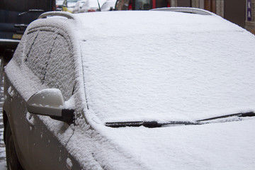 Car covered with fresh white snow
