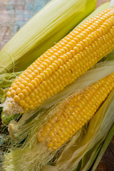 Fresh corn on rustic wooden table, closeup