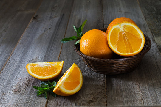 oranges with mint leaves closeup in a wicker basket