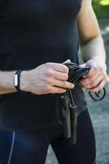 A young guy holding a rope in his hands to start playing sports