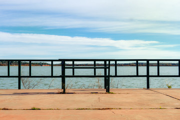 Esplanade with bench in front of a lagoon