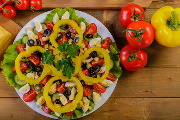 Vegetable salad with cherry tomatoes, olives, cheese, yellow pepper