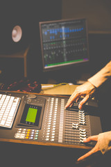 sound engineer hands working on digital sound mixer in recording, broadcasting, post production...