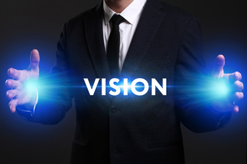 Business, Technology, Internet and network concept. Young businessman working on a virtual screen of the future and sees the inscription: Vision