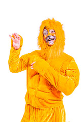Close-up portrait of smiling and fooling around animator in lion theater role. Plush lion suit. Emotional and colorful portrait. Isolated background