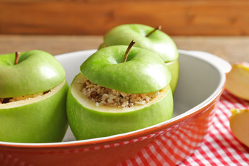 Fresh stuffed apples in baking dish on table, closeup